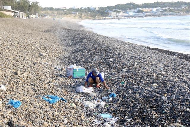 Man with love for nature saving pebble beach