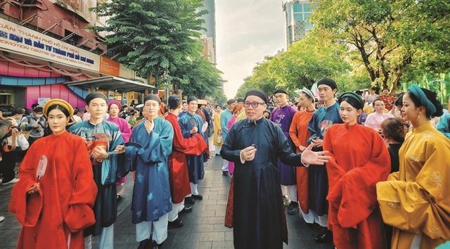 Parading in Vietnamese traditional costume in HCM City