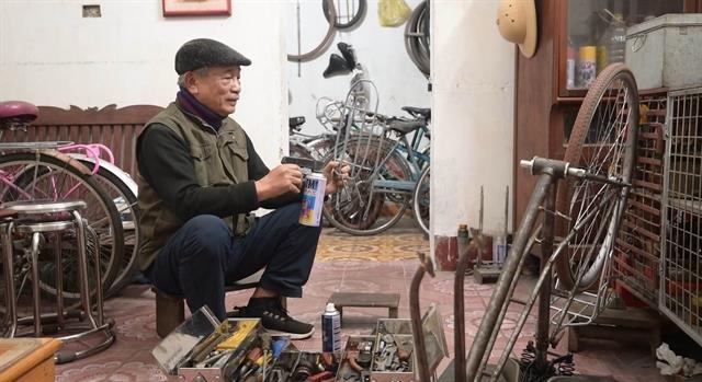 Old man recycles wheels, turning dreams into motion