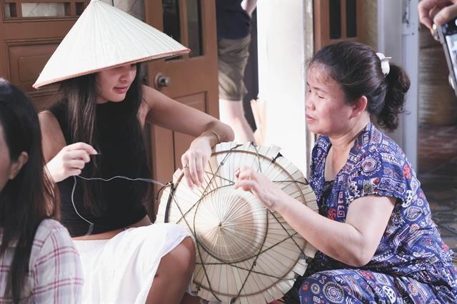Village keeps conical hat spirit alive